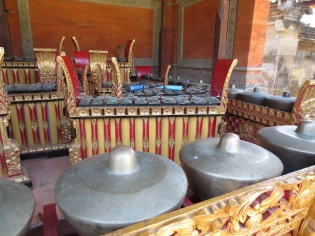 The instrument in front is essentially a set of small gongs mounted on a rack, played with cord-wrapped sticks. The one behind is like a metal xylophone.