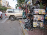 There's much to admire in this photo. The SUV parked nonchalantly into the street, the disappearance of the sidewalk beneath a shoe "display," etc. Walking around Phnom Penh is a bit of a challenge.